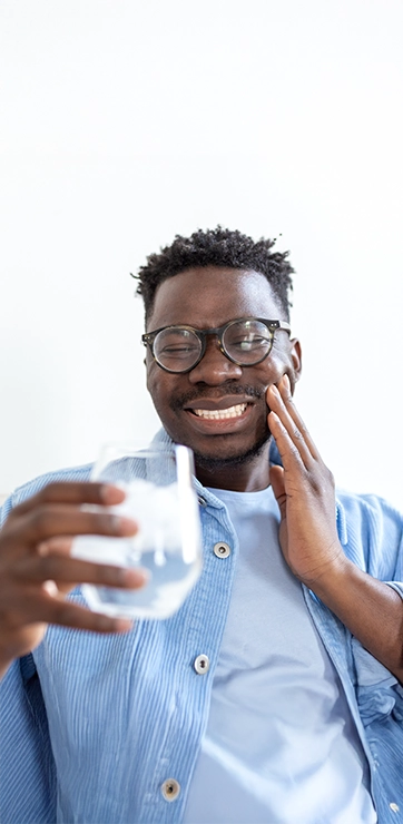 Man Drinking A Glass Of Water With Tooth Pain Holding His Jaw